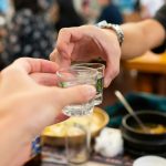 person holding clear drinking glass with water